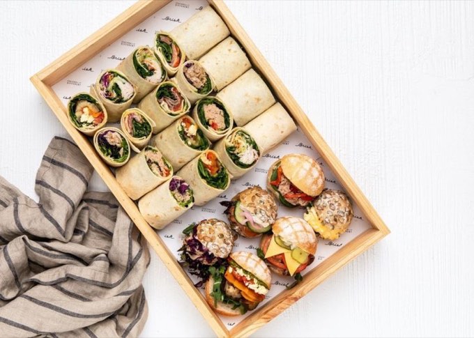 Individually presented wraps and rolls on a catering platter